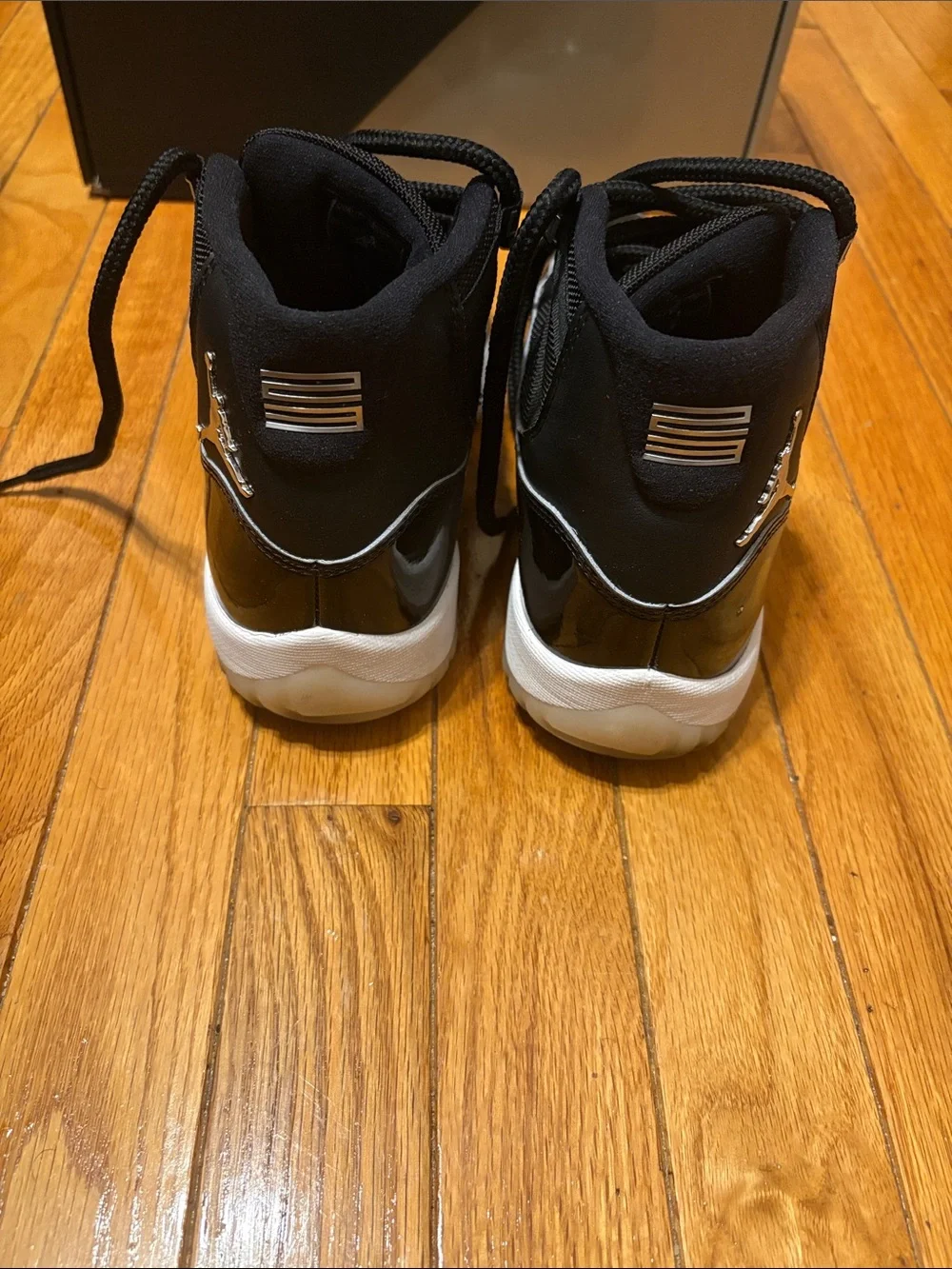 Air Jordan 11 Retro Black Patent and White-Trim High-Top Sneakers